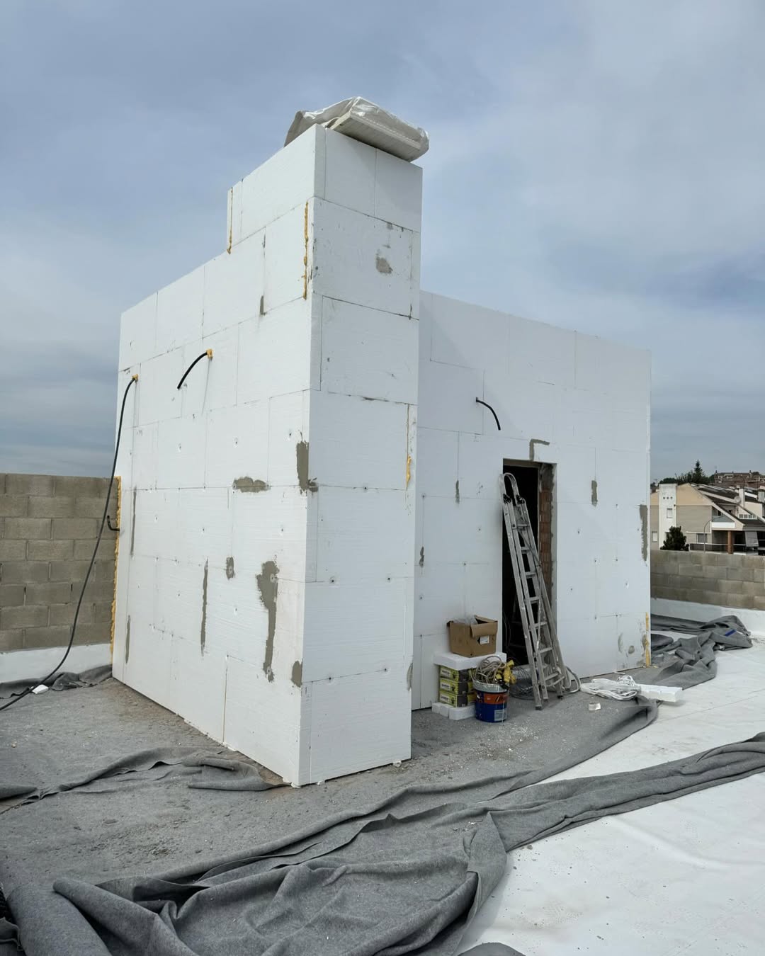 Fachada de edificio siendo rehabilitada con sistema SATE (Sistema de Aislamiento Térmico Exterior). Ahorro energético y rehabilitación de edificios en Barcelona